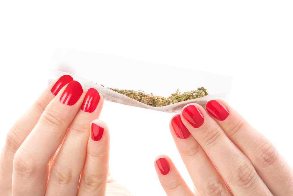 closeupofwomanrollingajoint.jpg