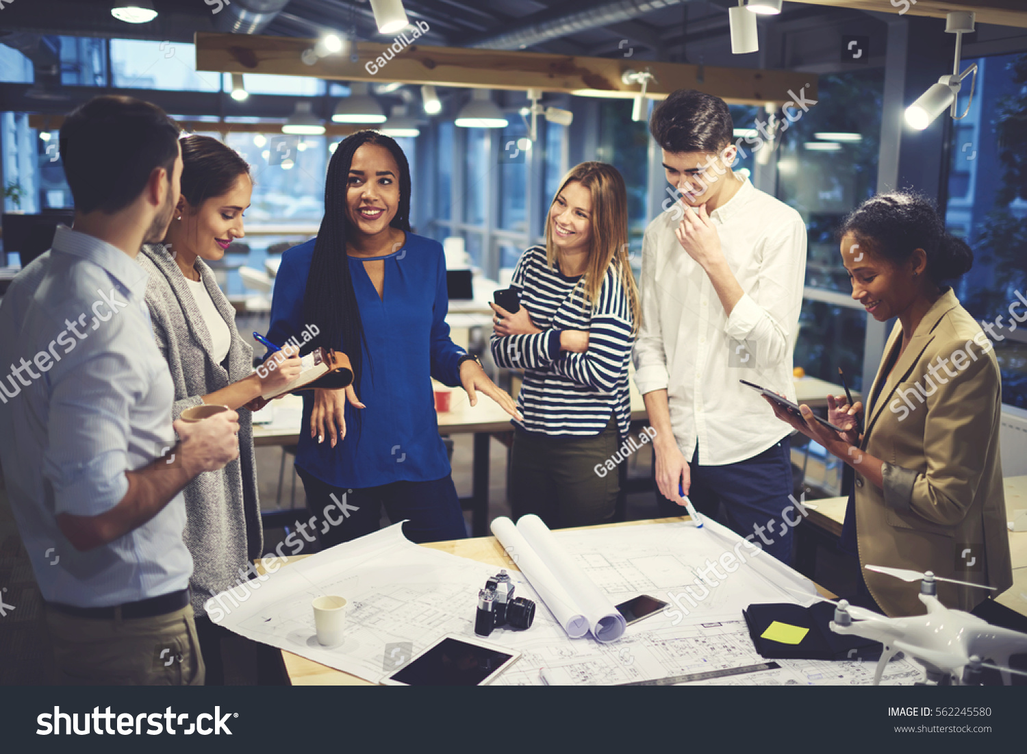 stock-photo-studying-group-of-male-and-female-designers-working-in-friendly-atmosphere-creating-map-of-city-562245580.jpg
