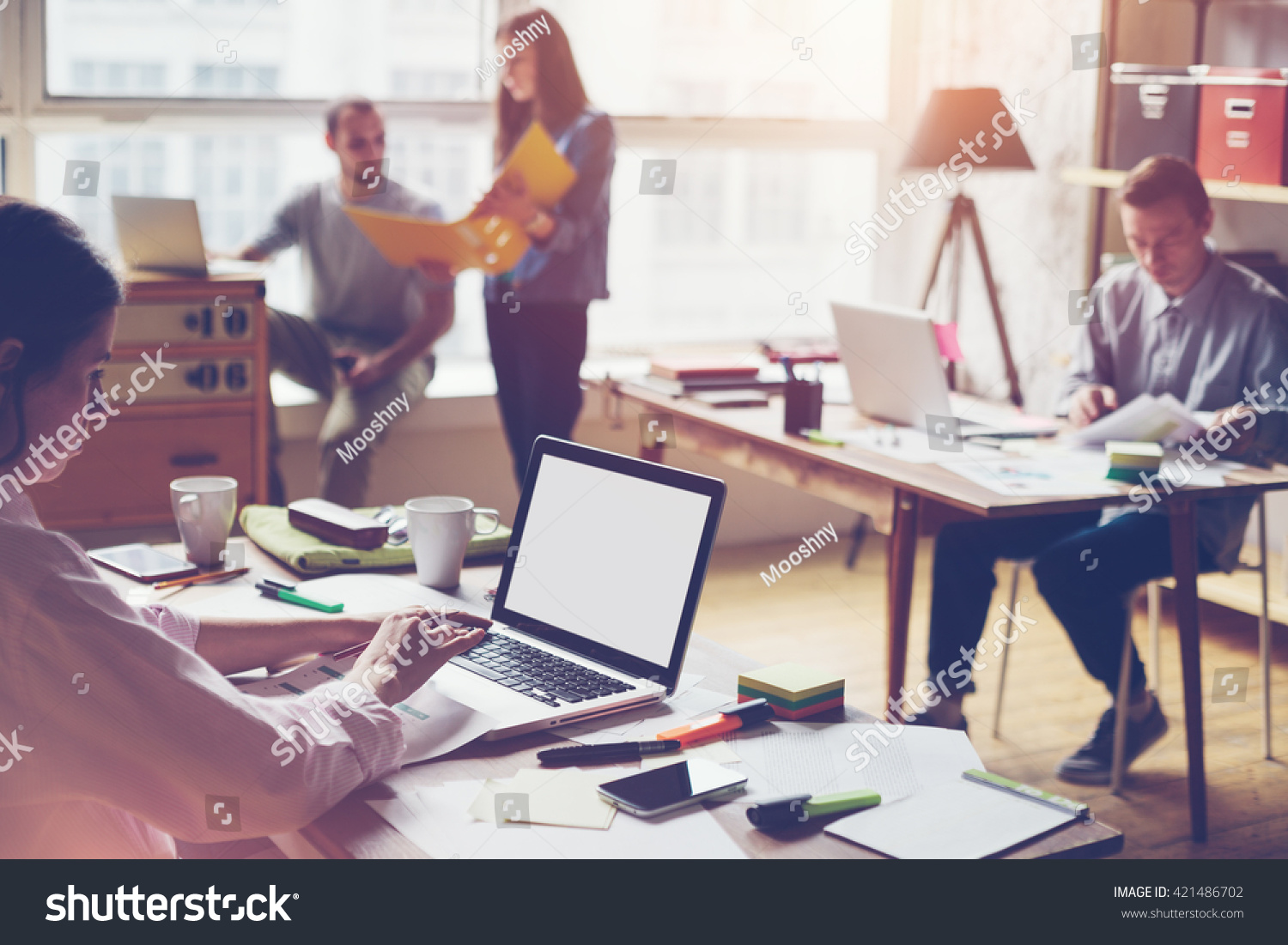 stock-photo-team-working-in-big-loft-office-laptop-typing-and-new-project-discussing-421486702.jpg