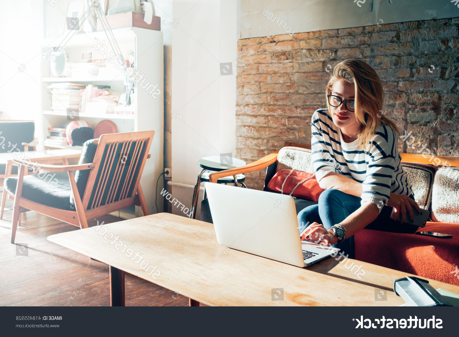 stock-photo-beautiful-young-blonde-female-student-using-portable-laptop-computer-while-sitting-in-a-vintage-418455928.jpg