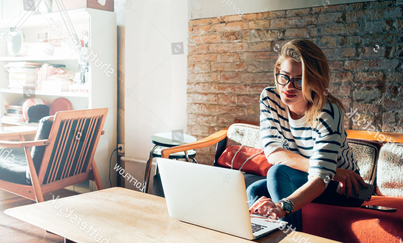 stock-photo-beautiful-young-blonde-female-student-using-portable-laptop-computer-while-sitting-in-a-vintage-418455928.jpg