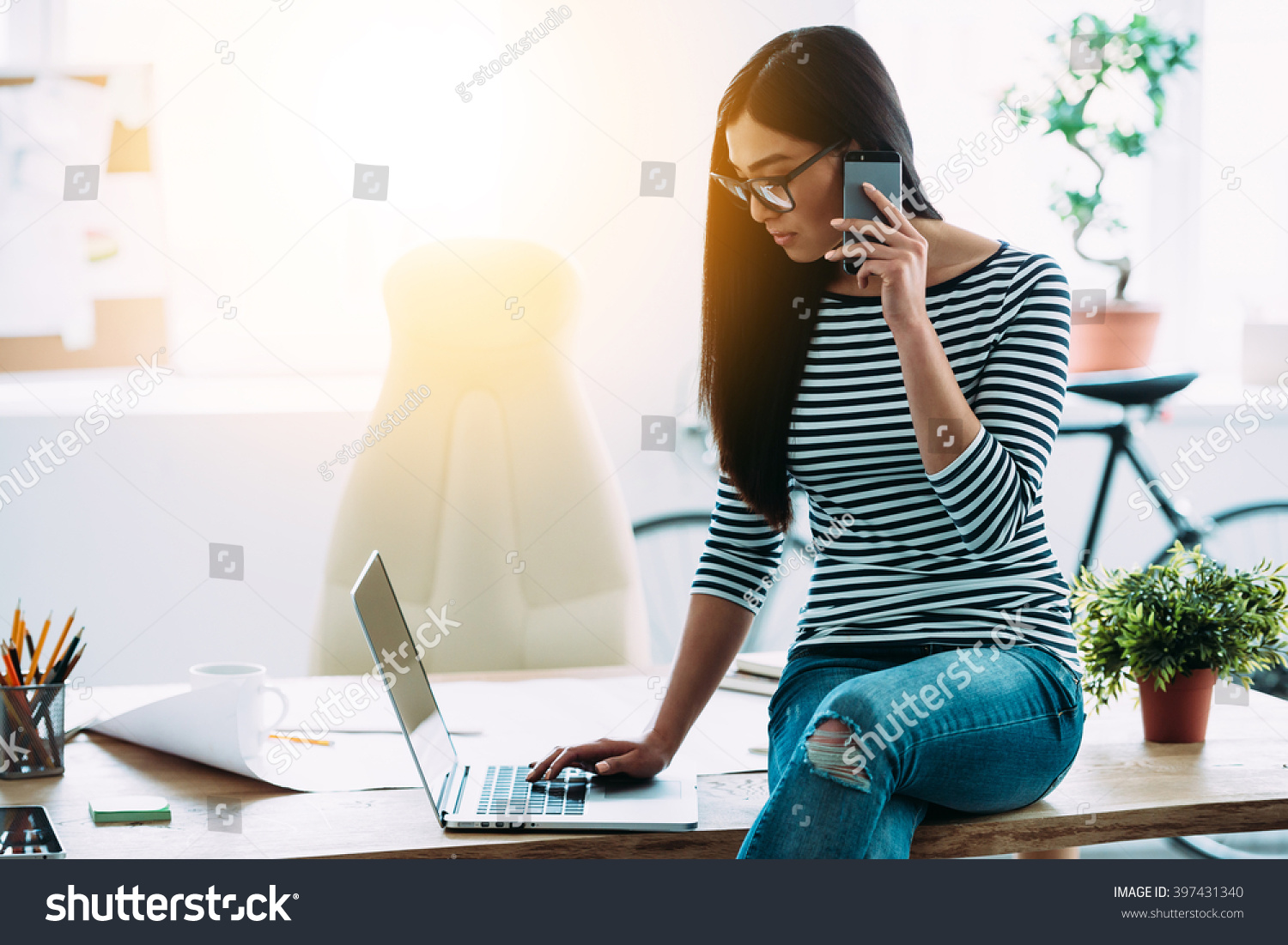 stock-photo-casual-working-day-of-architect-beautiful-young-asian-woman-in-glasses-talking-on-mobile-phone-and-397431340.jpg