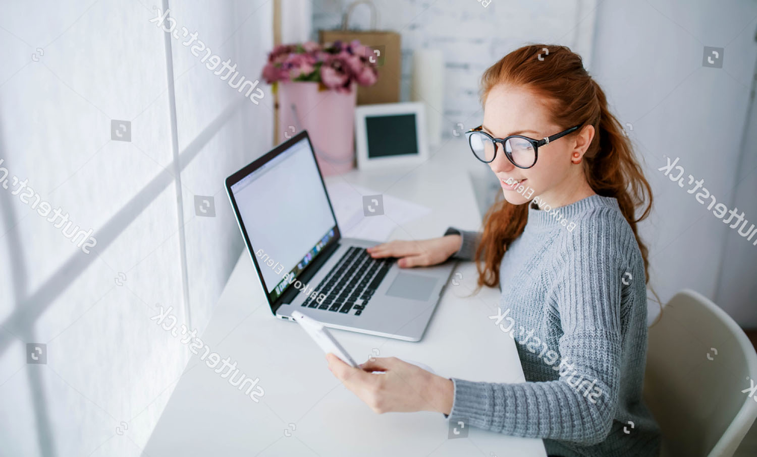 stock-photo-young-beautiful-woman-with-red-hair-wearing-glasses-working-in-the-office-uses-a-laptop-and-560751952.jpg