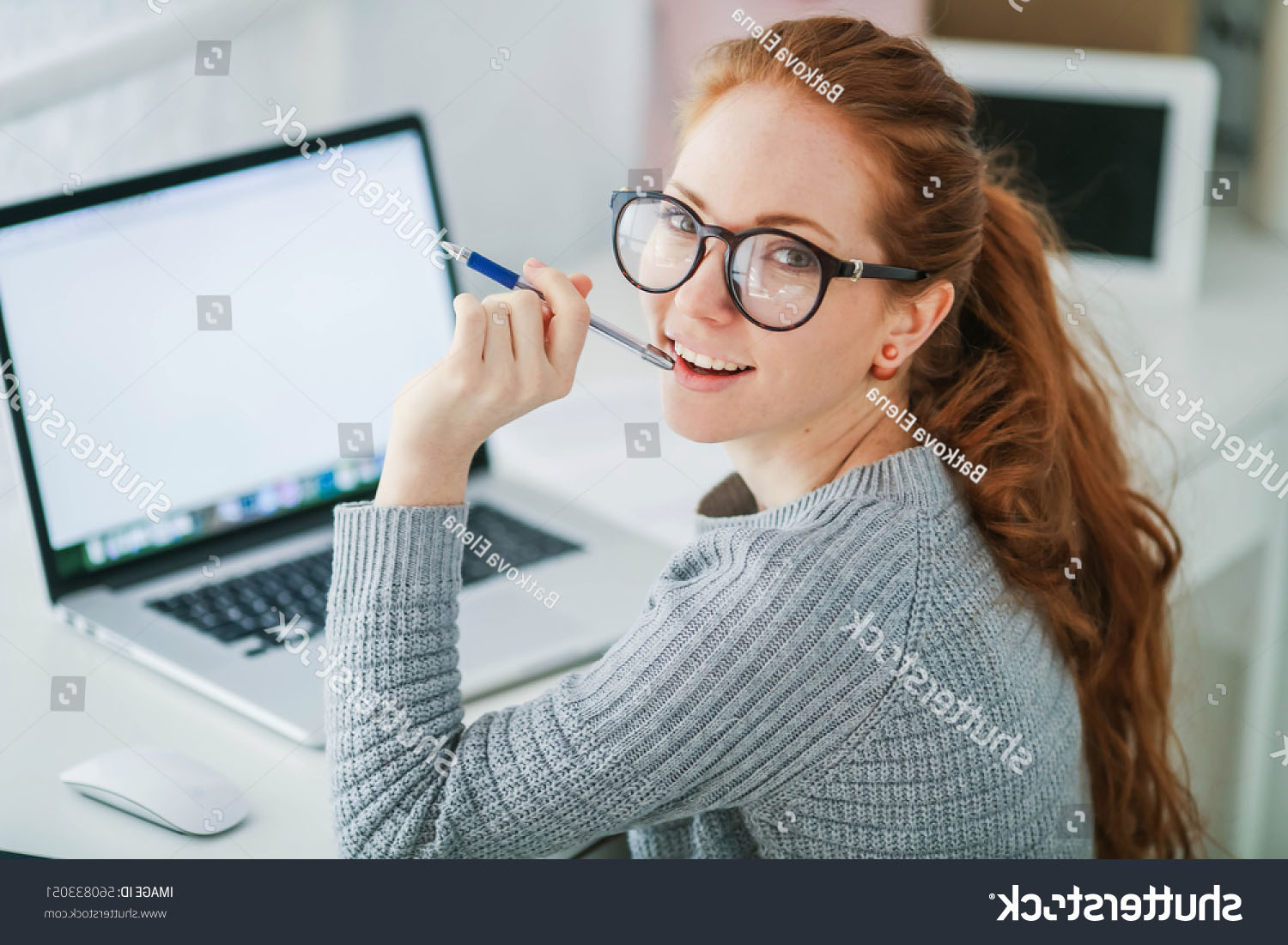 stock-photo-young-beautiful-woman-with-red-hair-wearing-glasses-working-in-the-office-uses-a-laptop-and-560833051.jpg