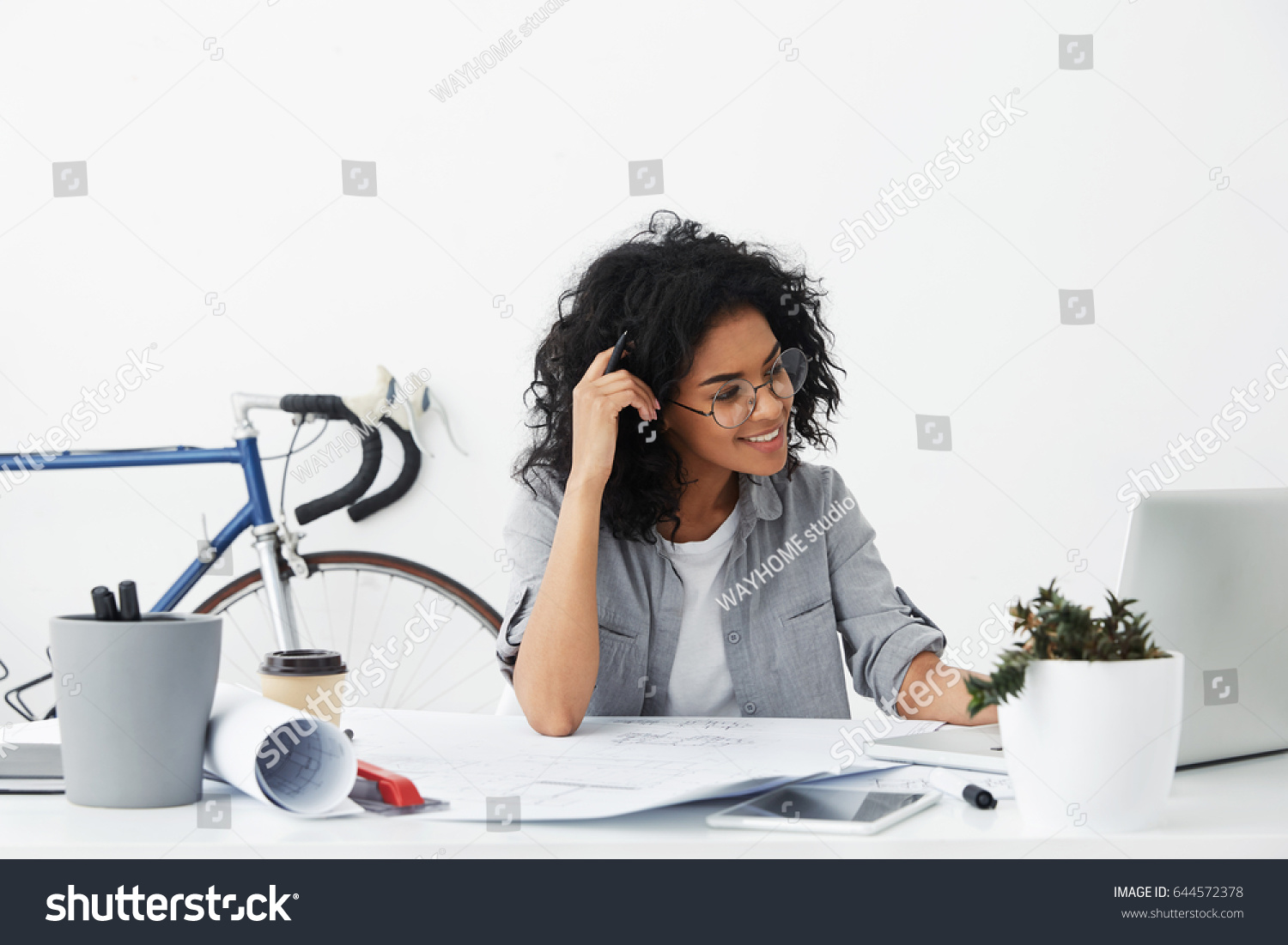 stock-photo-positive-young-beautiful-american-woman-wearing-stylish-shirt-and-big-round-glasses-making-drawings-644572378.jpg