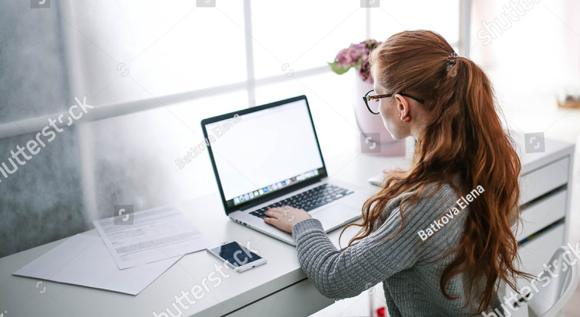 stock-photo-young-beautiful-woman-with-red-hair-wearing-glasses-working-in-the-office-uses-a-laptop-and-560751844.jpg