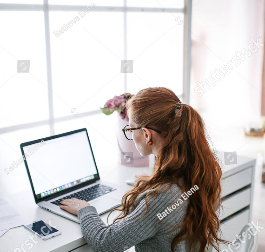 stock-photo-young-beautiful-woman-with-red-hair-wearing-glasses-working-in-the-office-uses-a-laptop-and-560751844.jpg
