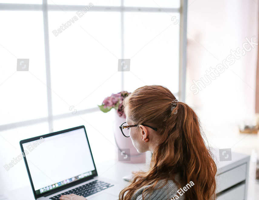 stock-photo-young-beautiful-woman-with-red-hair-wearing-glasses-working-in-the-office-uses-a-laptop-and-560751844.jpg