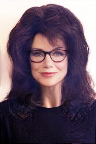 Woman with big hair and glasses